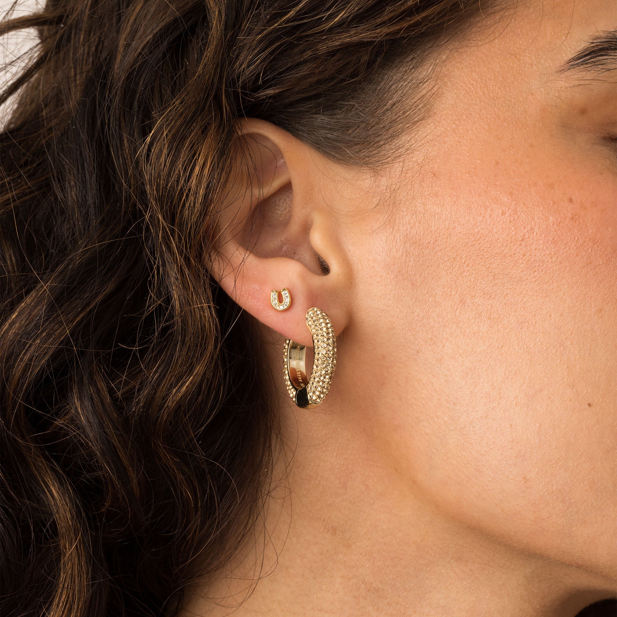 Mini Horseshoe Stud Earrings on model