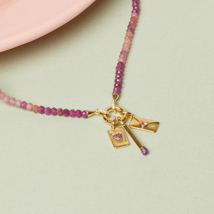 Ace of Hearts Charm, Matchstick Charm, and Love Letter Charm on Warm Gradient Charm Necklace.