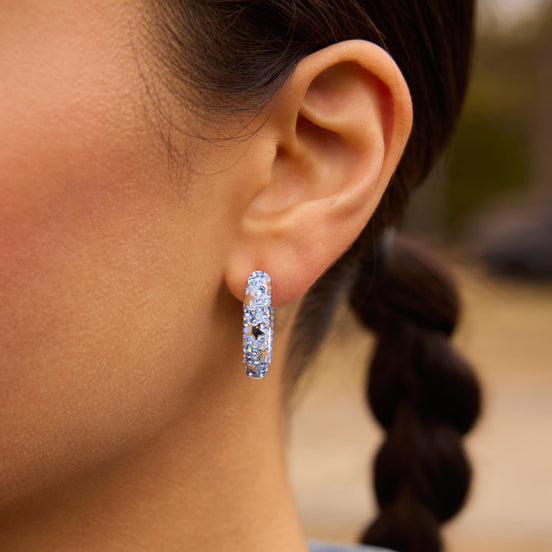 Denim Star Studded Medium Sparkle Hoop Earrings close up on model