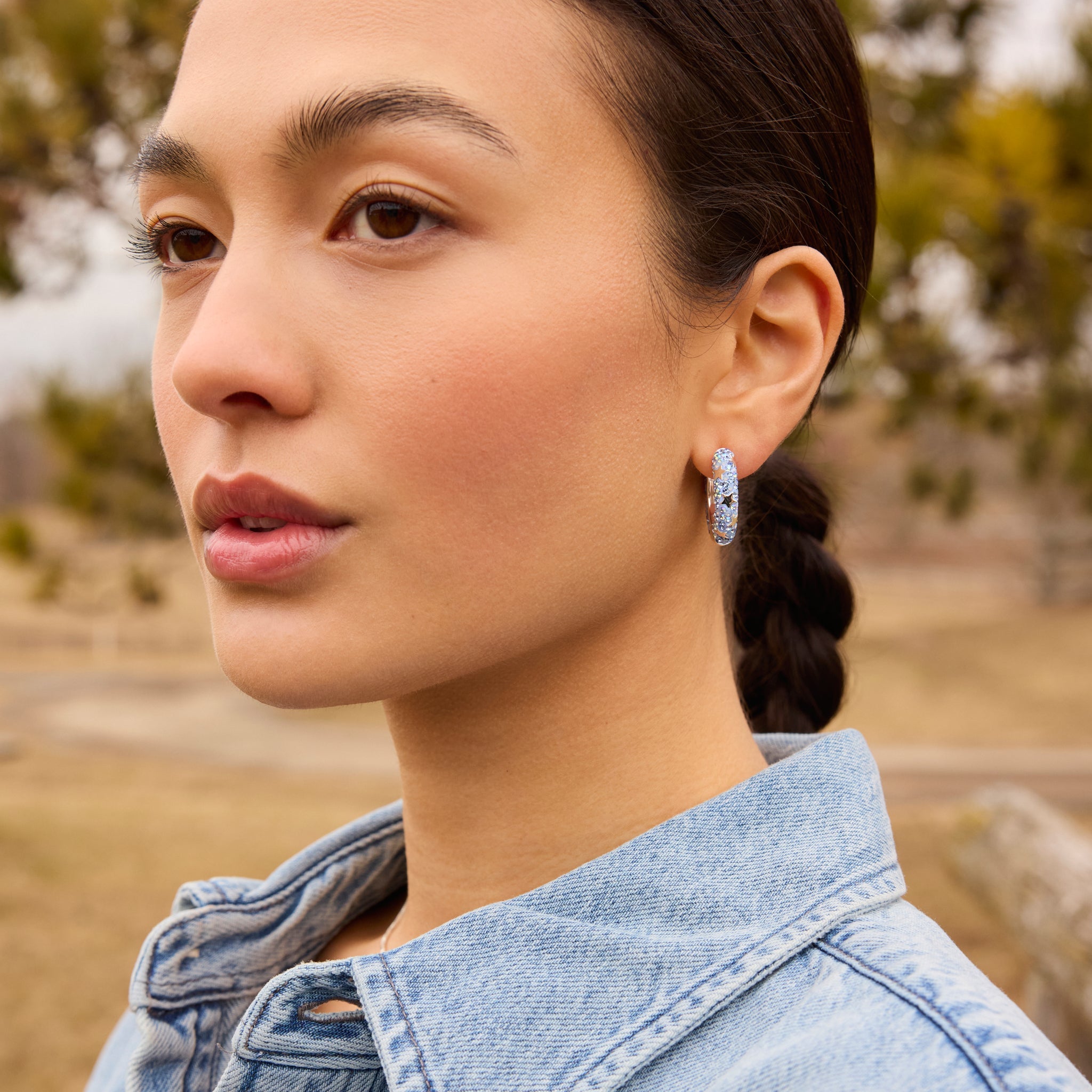 Denim Star Studded Medium Sparkle Hoop Earrings on model