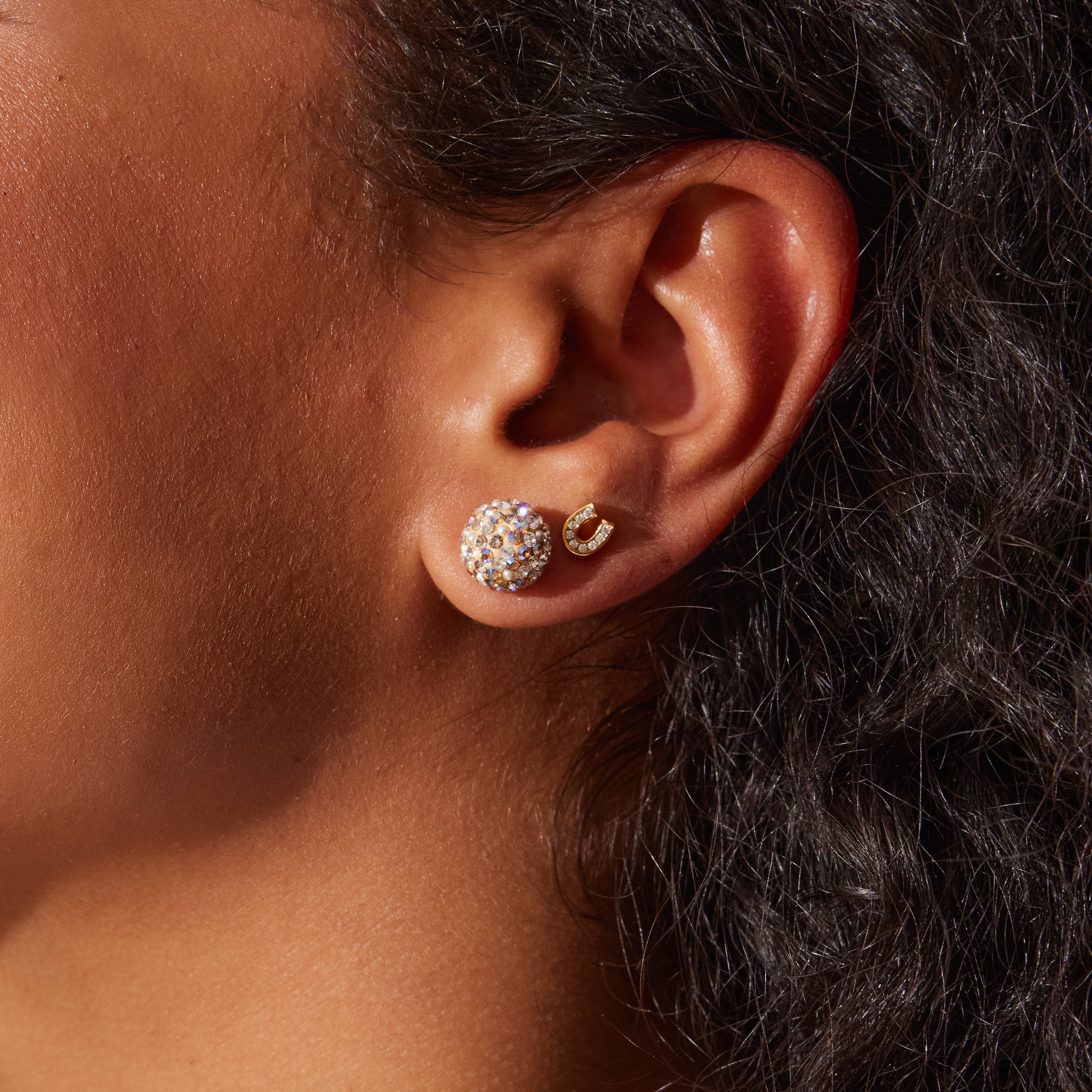 Mini Horseshoe Stud Earrings on model