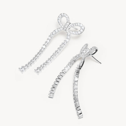 Tennis Bow Statement Earrings laying flat
