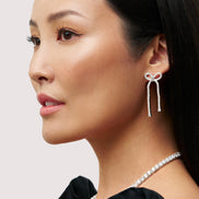 Tennis Bow Statement Earrings on model